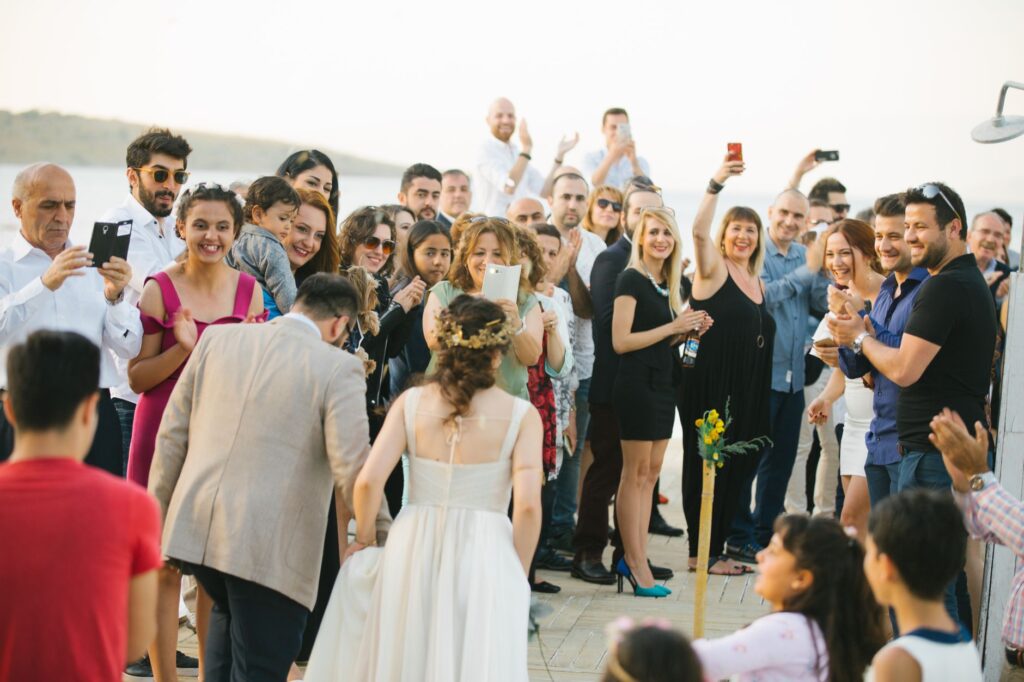 A candid moment of guests enjoying a wedding reception, captured by a professional photographer. — wedding photographers…