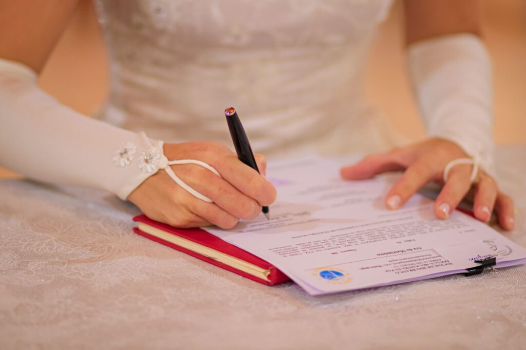 A close-up of a wedding officiant holding a marriage certificate during a ceremony. — Las Vegas wedding officiant