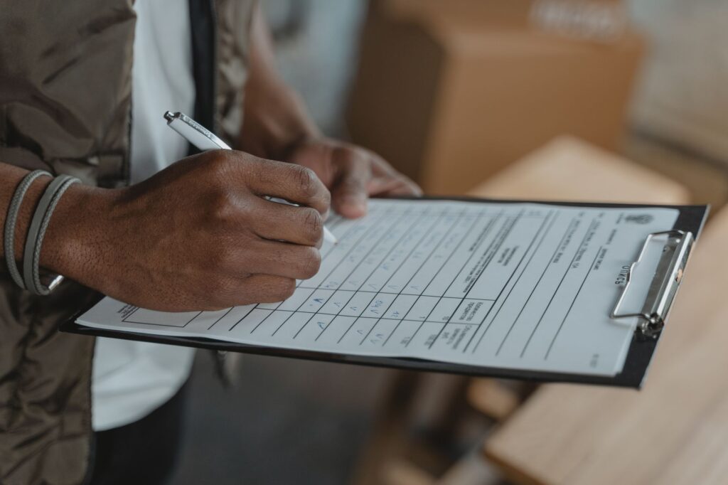 A close-up shot of a wedding photo checklist being filled out with a pen. — las vegas wedding photographer