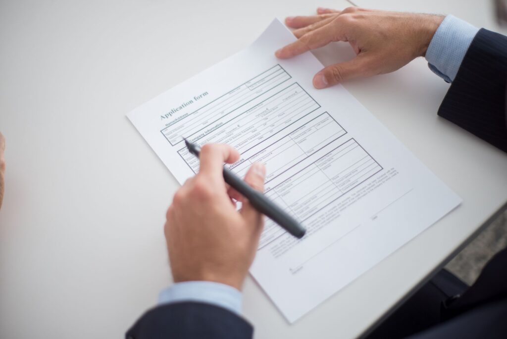 A close-up shot of the wedding license application form with a pen. — Las Vegas wedding license requirements