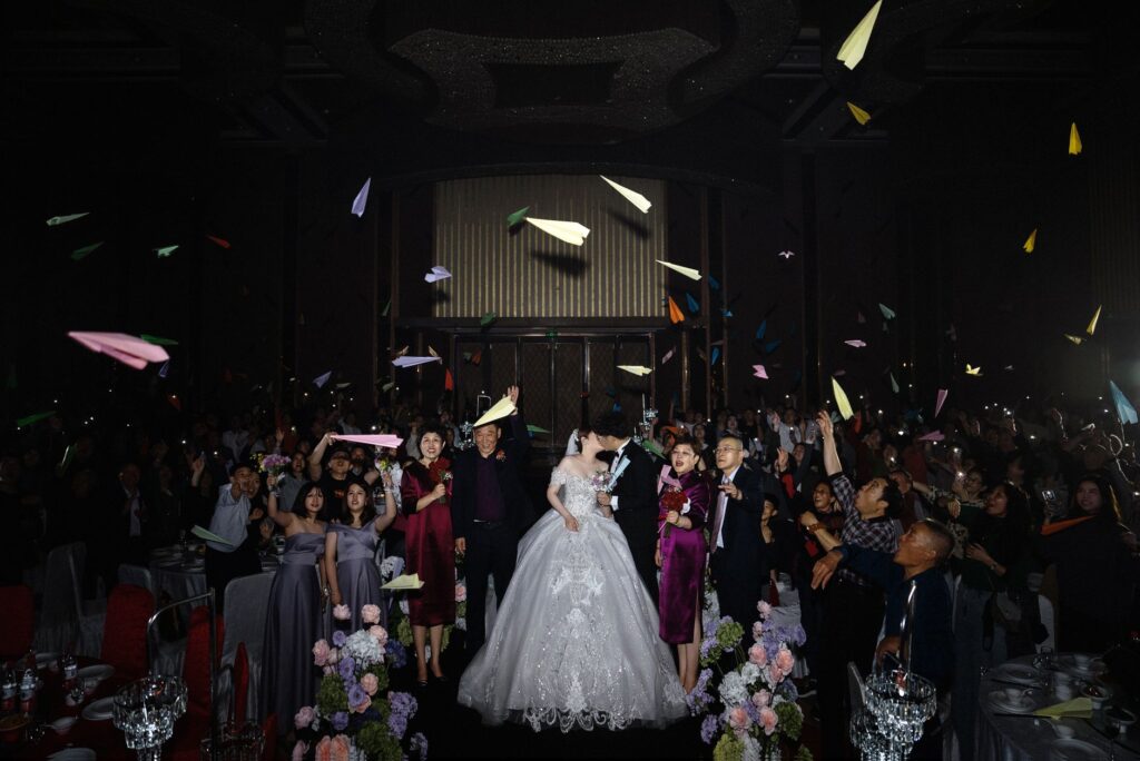A couple celebrating their wedding with friends and family in a reception hall. — Las Vegas wedding packages