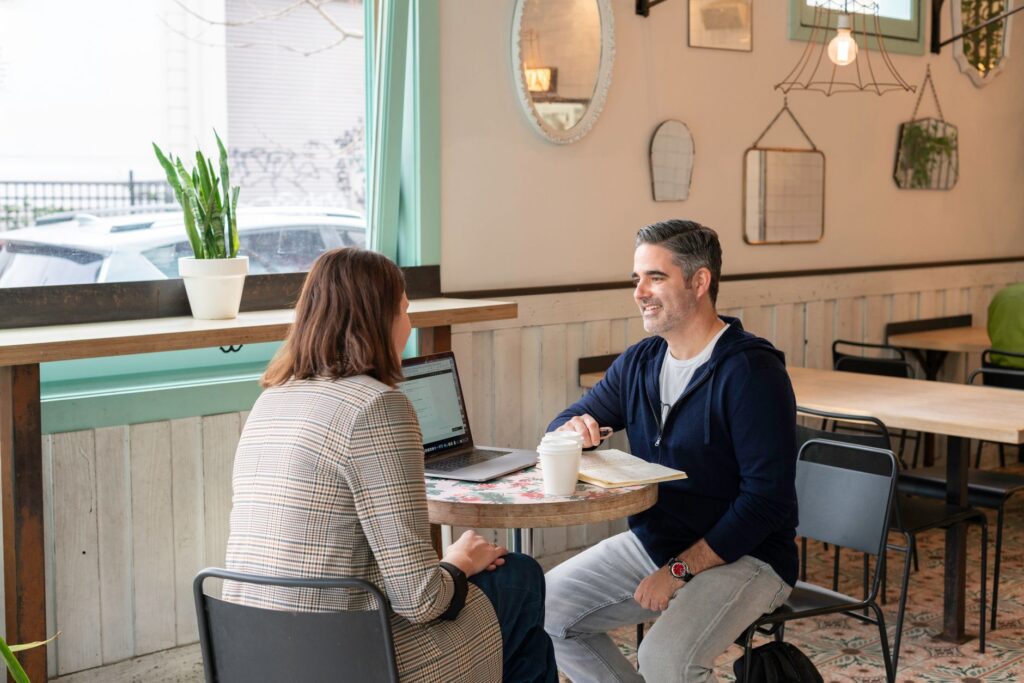 A couple discussing their wedding budget with a planner at a cafe. — save money Las Vegas wedding