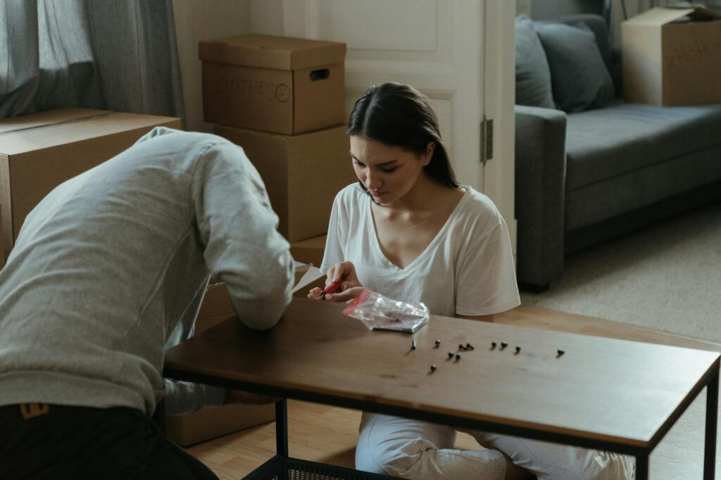 A couple happily working on DIY wedding decorations in a cozy home setting. — Las Vegas wedding budgeting tips