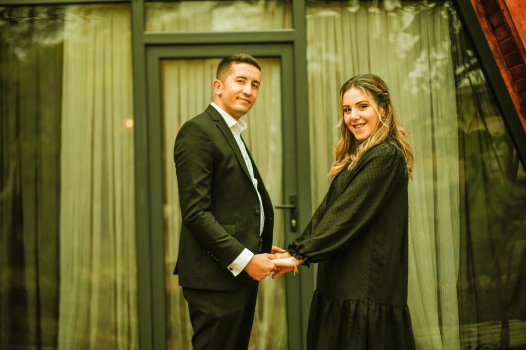 A couple standing in front of a Las Vegas wedding chapel, smiling and holding hands. — marriage license Las Vegas