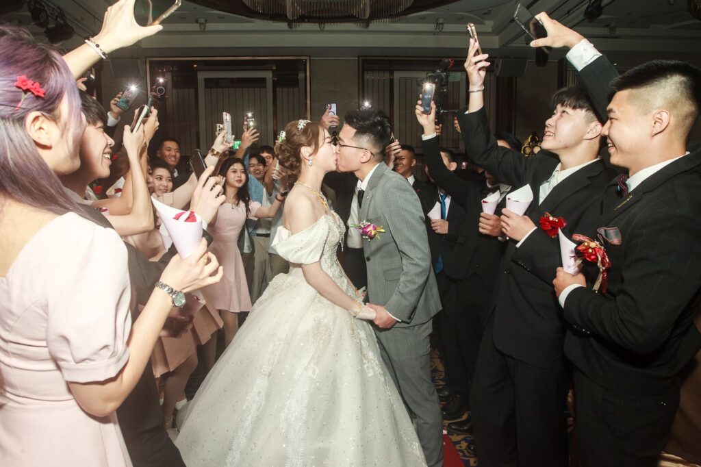 A joyful bride and groom celebrating with family and friends at a high-end wedding reception, capturing the essence of a luxury las vegas wedding.