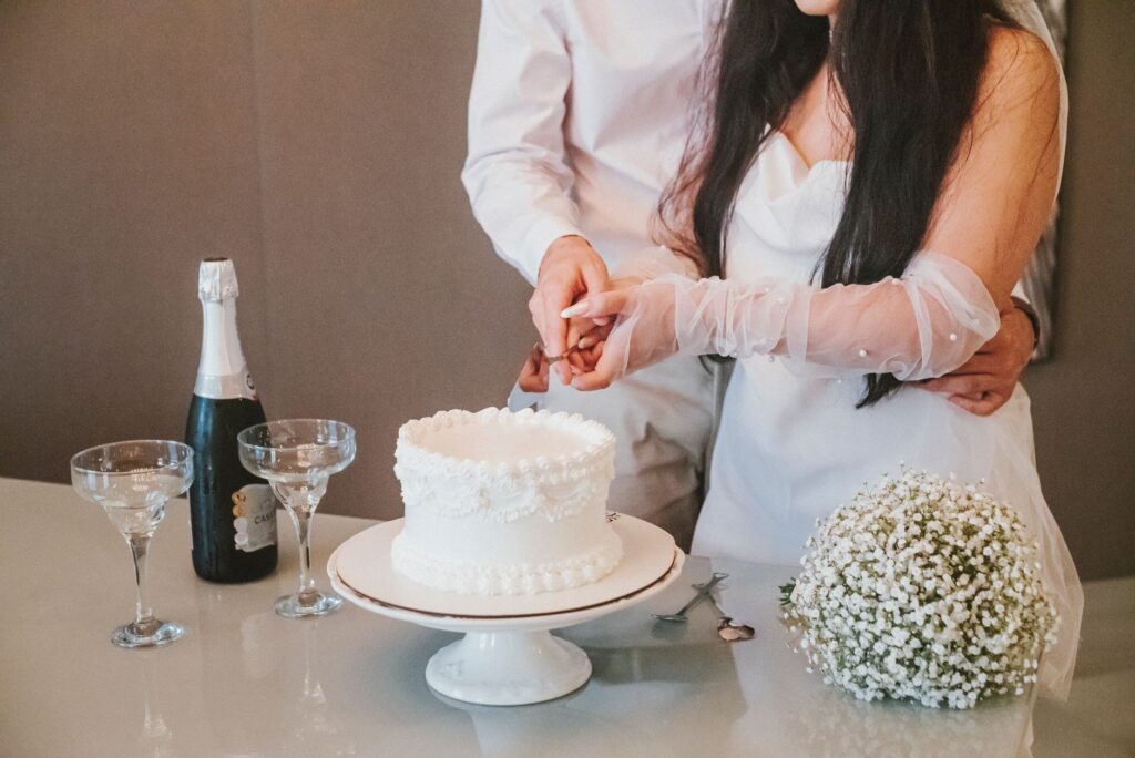 A joyful couple celebrating their elopement with a cake or toast. — Las Vegas elopement tips