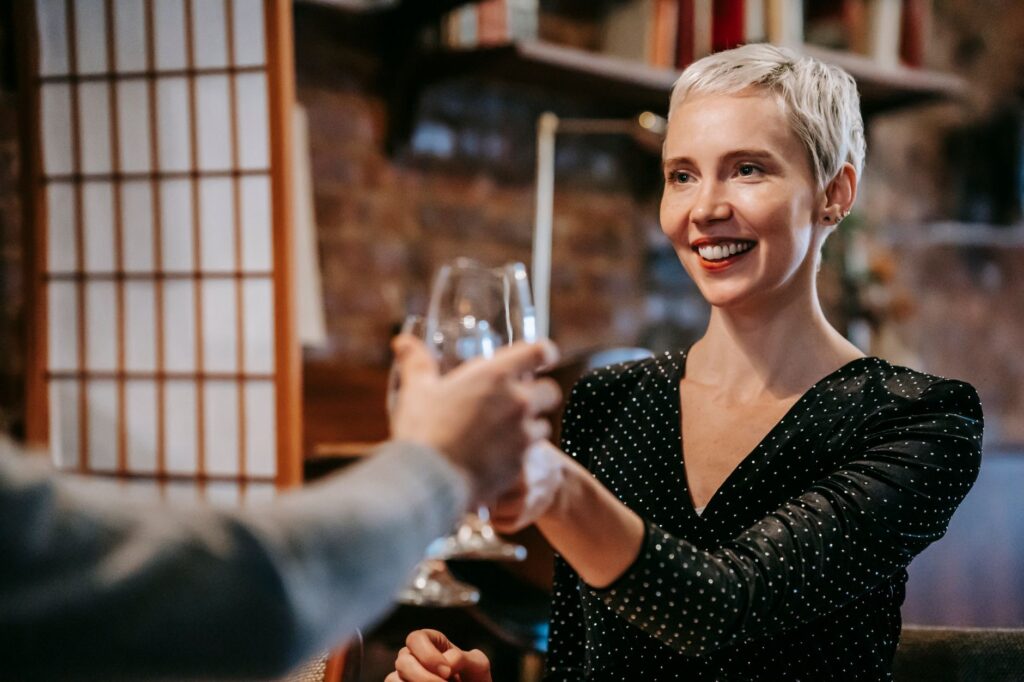 A joyful couple celebrating their elopement with a toast at a chic restaurant in Las Vegas. — Las Vegas elopement planning