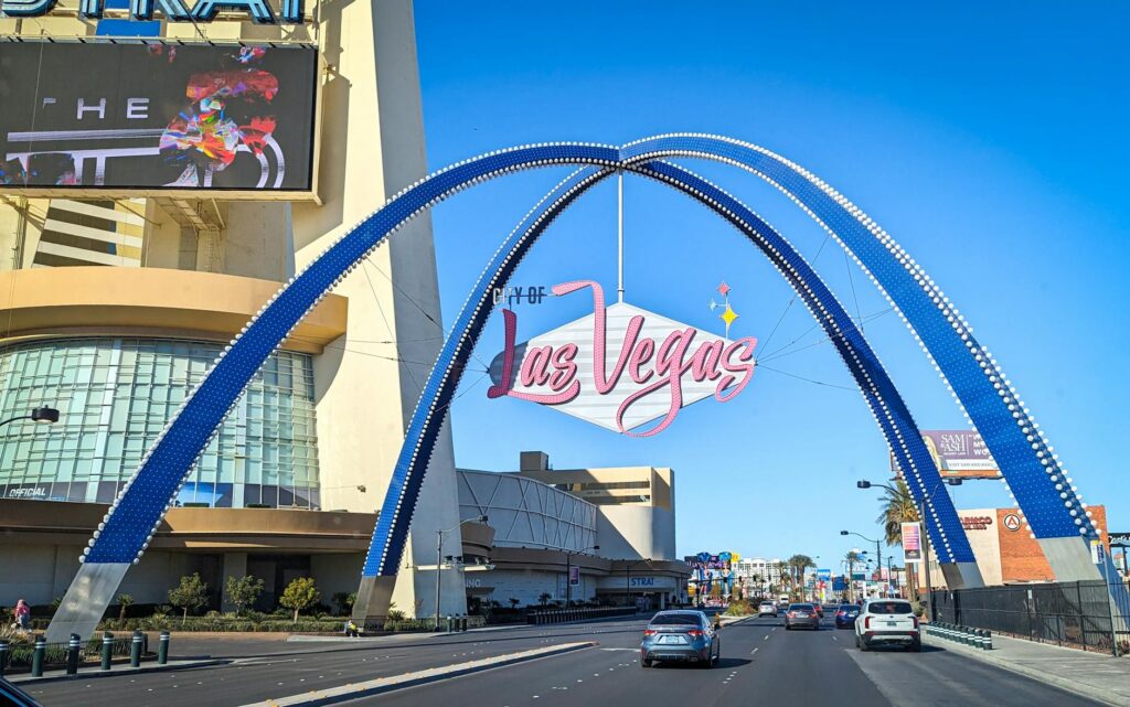 A joyful couple posing in front of the iconic Welcome to Fabulous Las Vegas sign. — Las Vegas wedding photographers