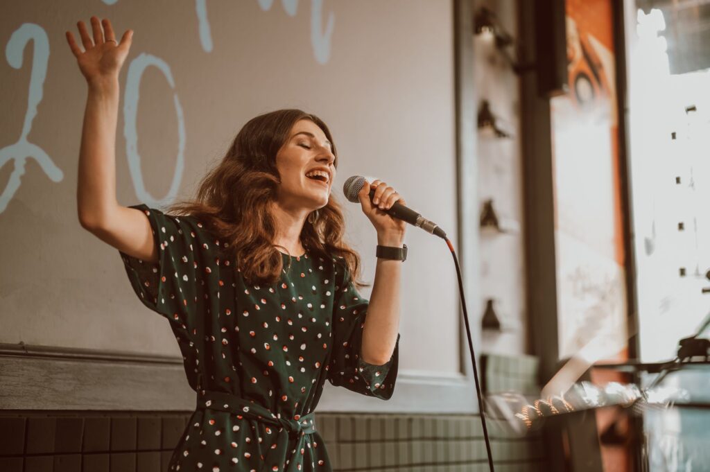 A lively wedding karaoke session with guests singing on stage. — unique wedding activities Las Vegas