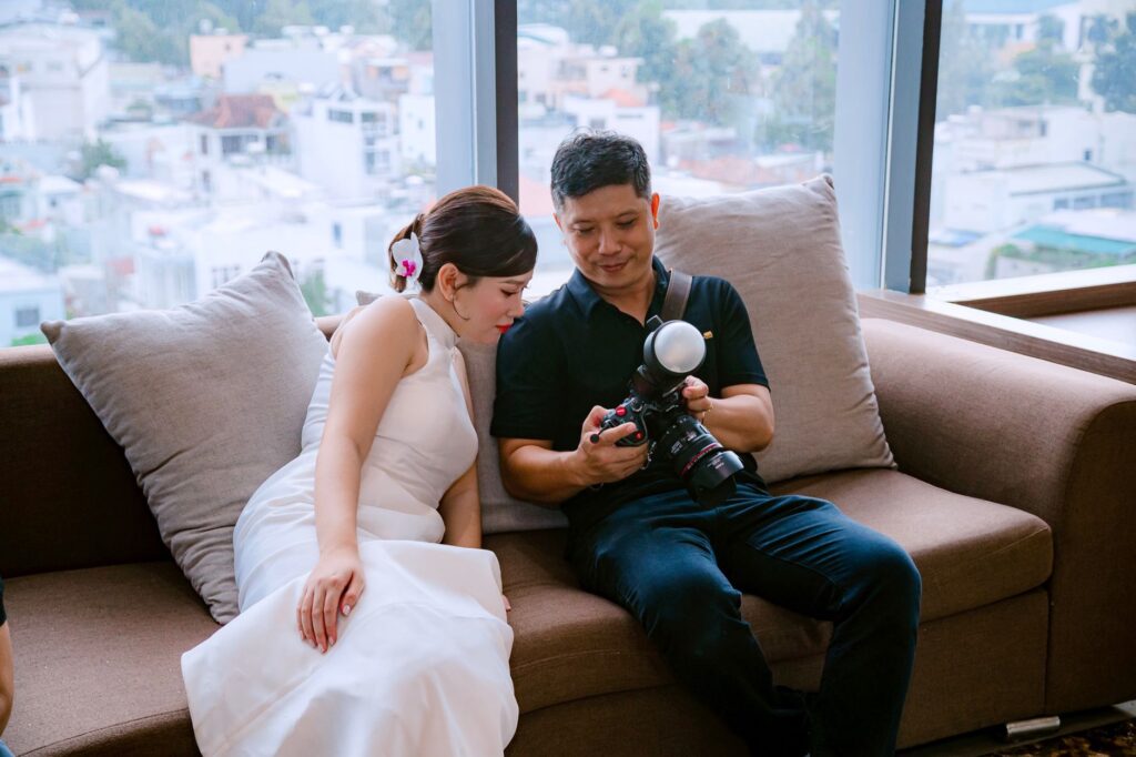 A photographer reviewing a wedding photography package with a couple. — Las Vegas wedding photographers