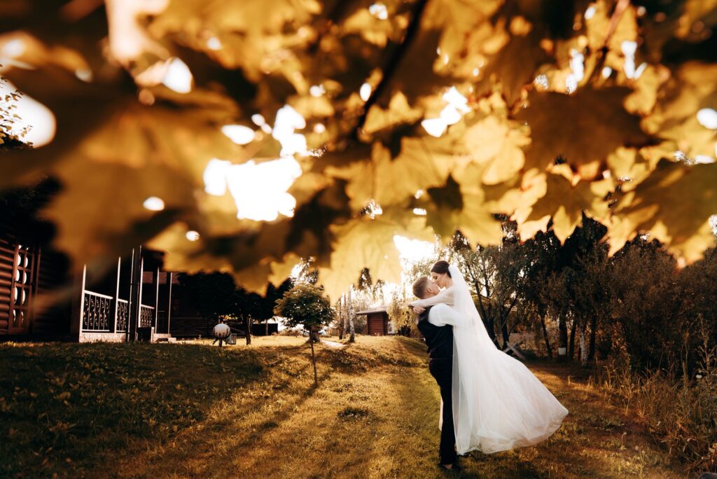 A picturesque fall wedding in Las Vegas with golden leaves and a sunset background, creating a romantic atmosphere. — be…