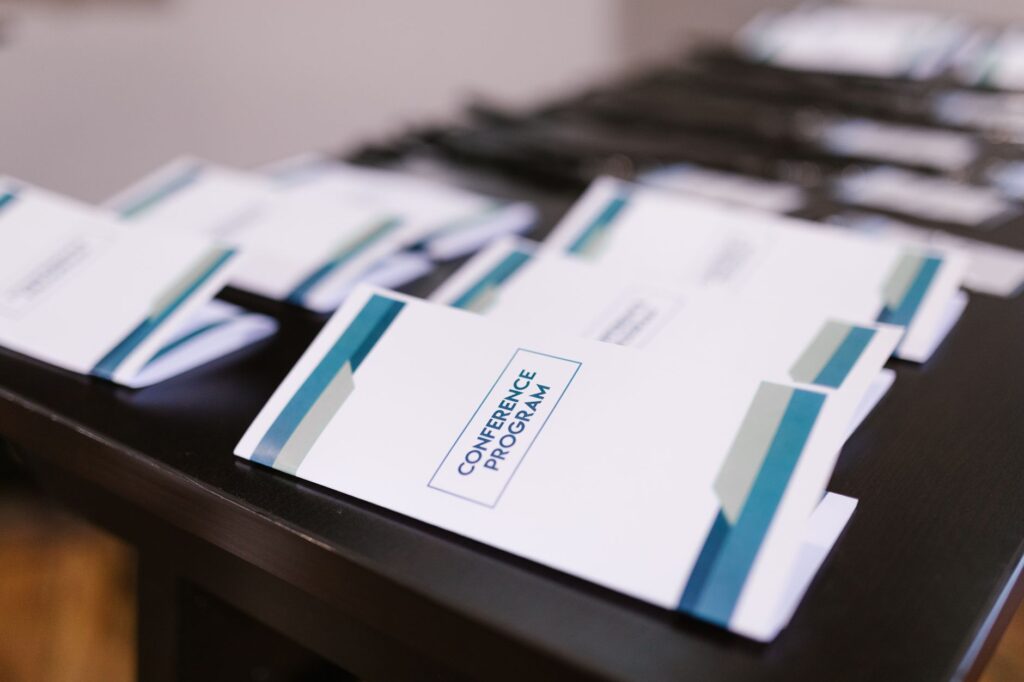 A table filled with wedding vendor brochures and samples related to Las Vegas wedding concierge services