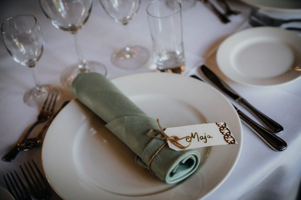 A table setting at a destination wedding with place cards for guests. — destination wedding guest list