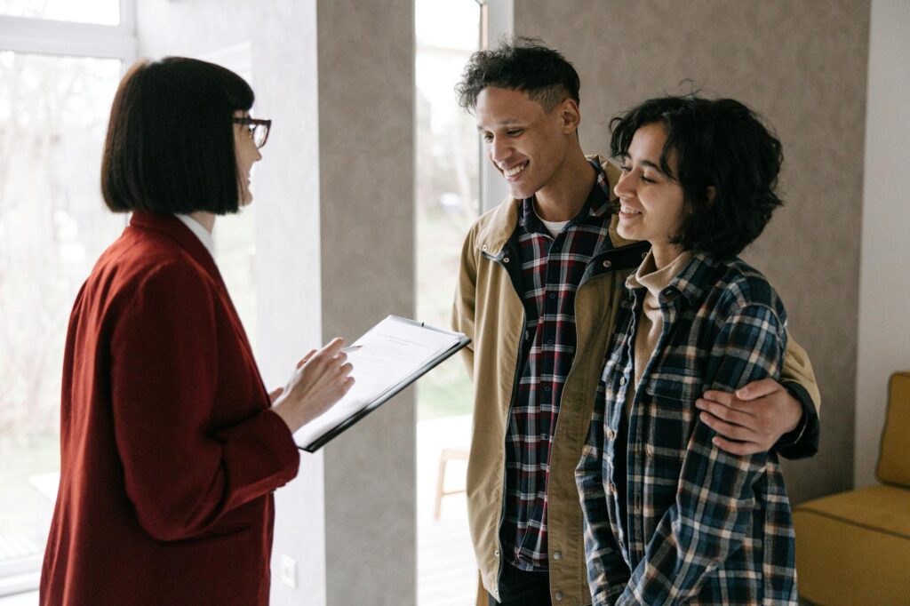 A wedding planner discussing details with a couple, highlighting the planning process in their las vegas wedding planning checklist.