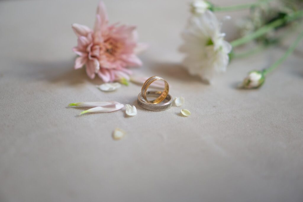 An artistic flat lay of wedding rings and flowers with a Las Vegas backdrop. — wedding photographers Las Vegas