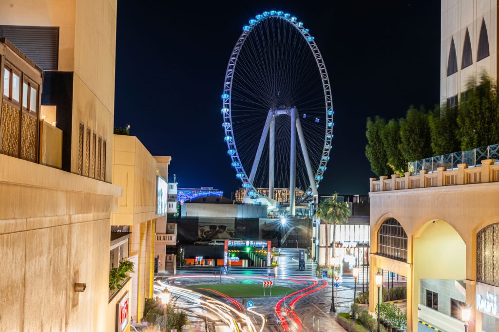 A breathtaking view of couples exchanging vows atop the High Roller Observation Wheel with the Las Vegas skyline in the ba…