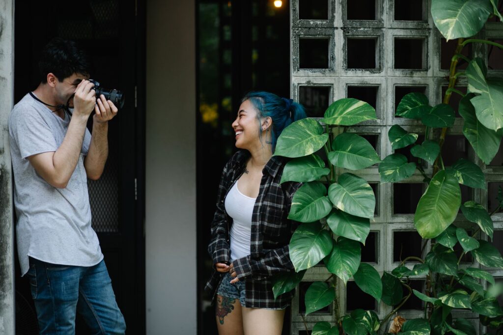 A candid shot of a couple laughing during their photo session with a professional photographer. — wedding photographers …