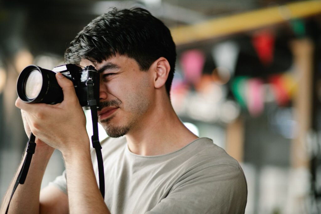 A close-up shot of a wedding photographer taking candid photos during a reception. — best wedding photographers Las Vegas