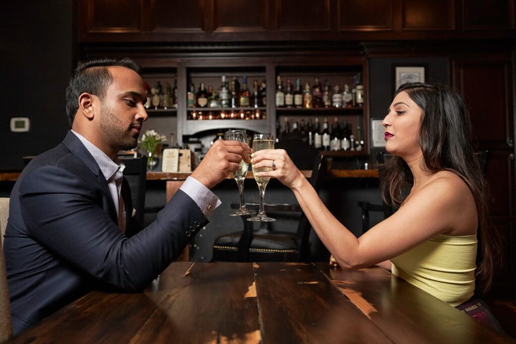 A couple celebrating their elopement with a toast in a chic Las Vegas restaurant. — stress-free elopement Las Vegas