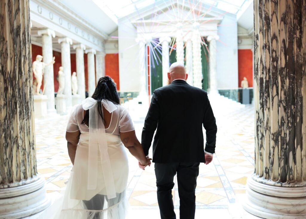 A couple celebrating their marriage surrounded by exhibits at the Mob Museum, highlighting the unique theme. — unique we…