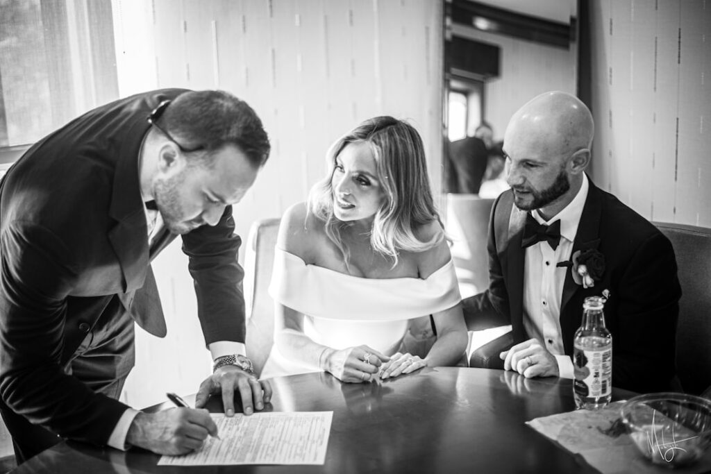 A couple discussing wedding plans with a hotel manager. — las vegas wedding hotel blocks