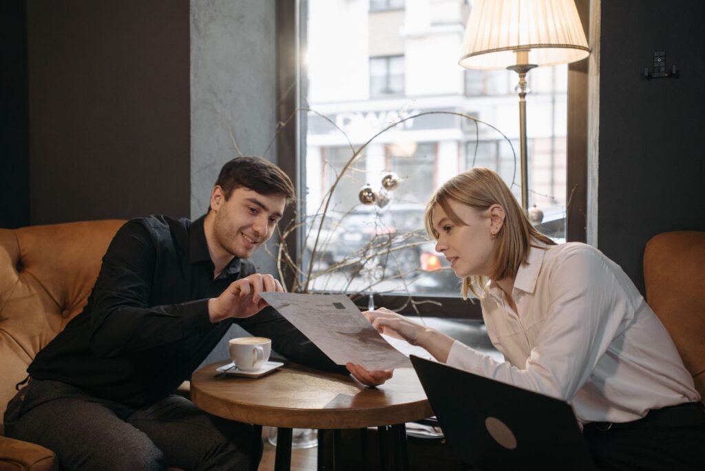 A couple discussing wedding plans with a local planner in a cozy cafe. — stress-free Las Vegas wedding