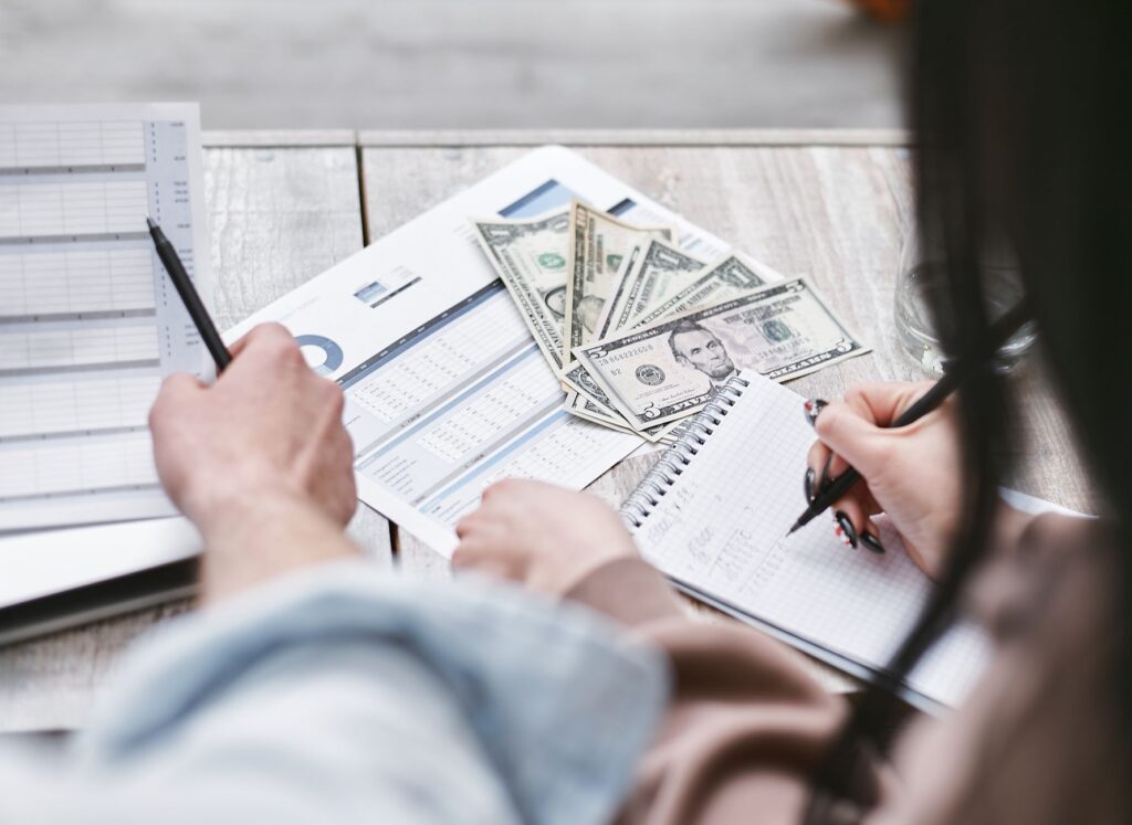 A couple happily planning their wedding budget with spreadsheets — Las Vegas wedding budgeting