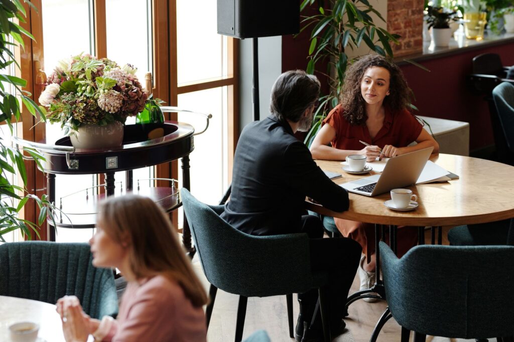 A couple meeting with a wedding concierge at a cafe or office. — wedding concierge checklist