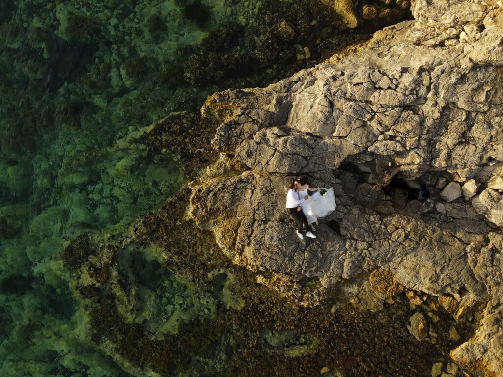 A couple using technology such as drones or live streaming to capture their wedding day from unique angles. — Las Vegas …