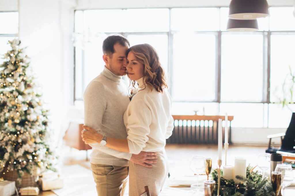 A cozy winter wedding scene in Las Vegas with festive decorations and couples celebrating together. — best time to marry…