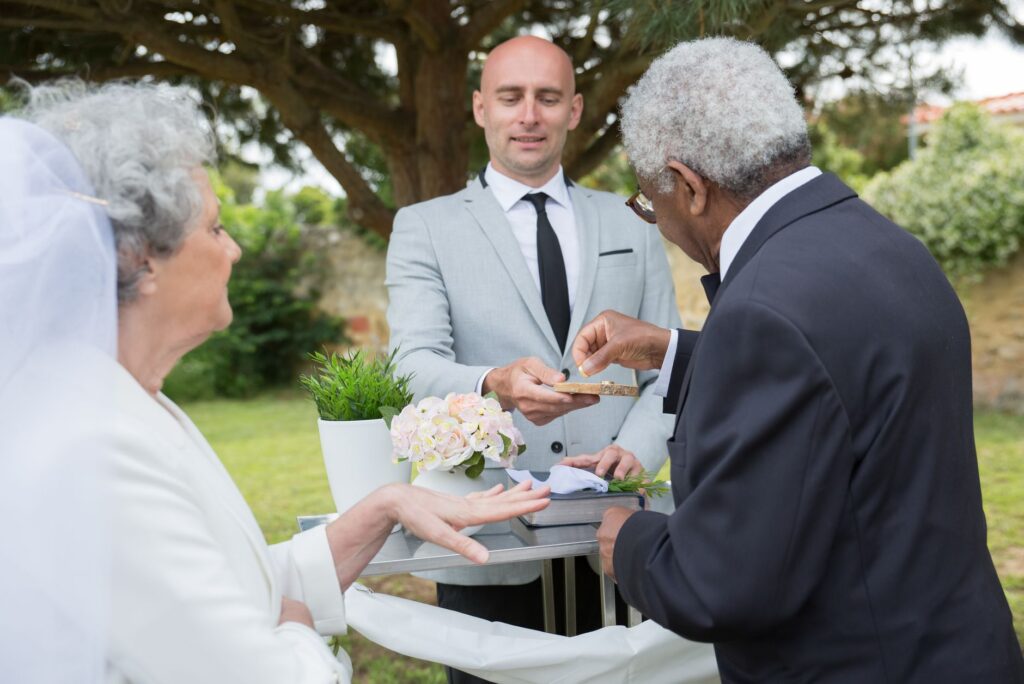 A happy couple exchanging rings with their officiant present. — Las Vegas wedding officiant