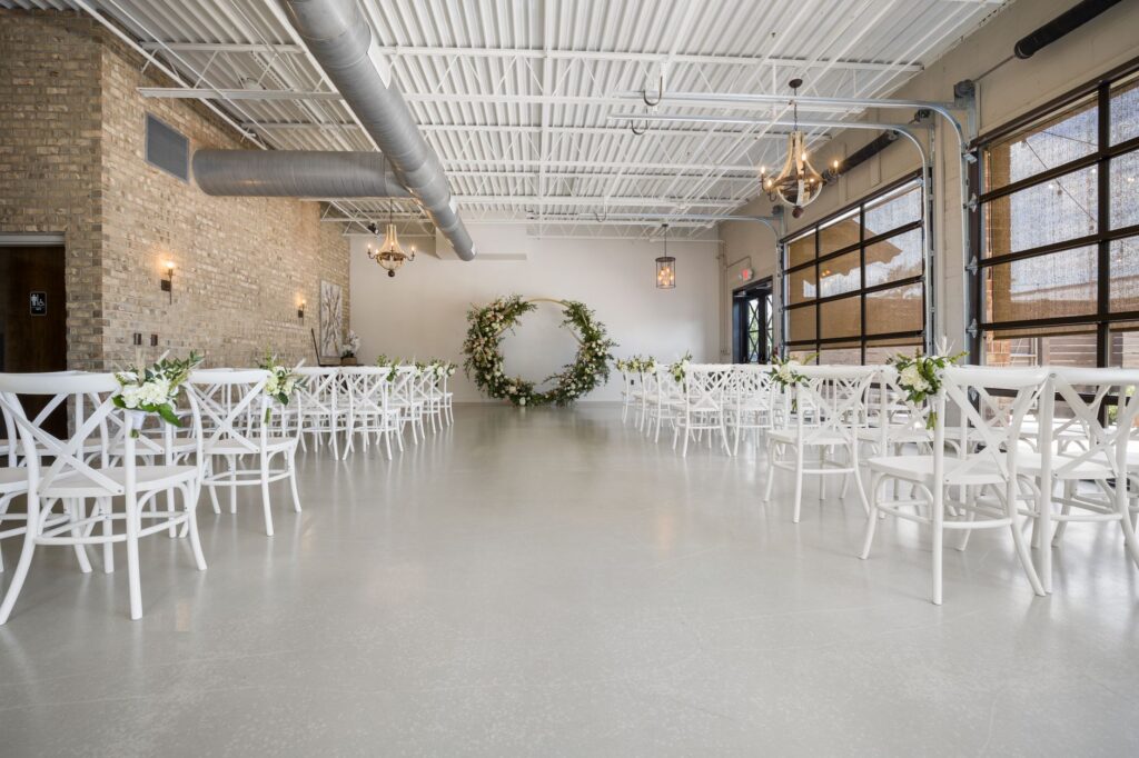 A minimalist wedding setup with elegant touches in an industrial venue. — Las Vegas wedding themes