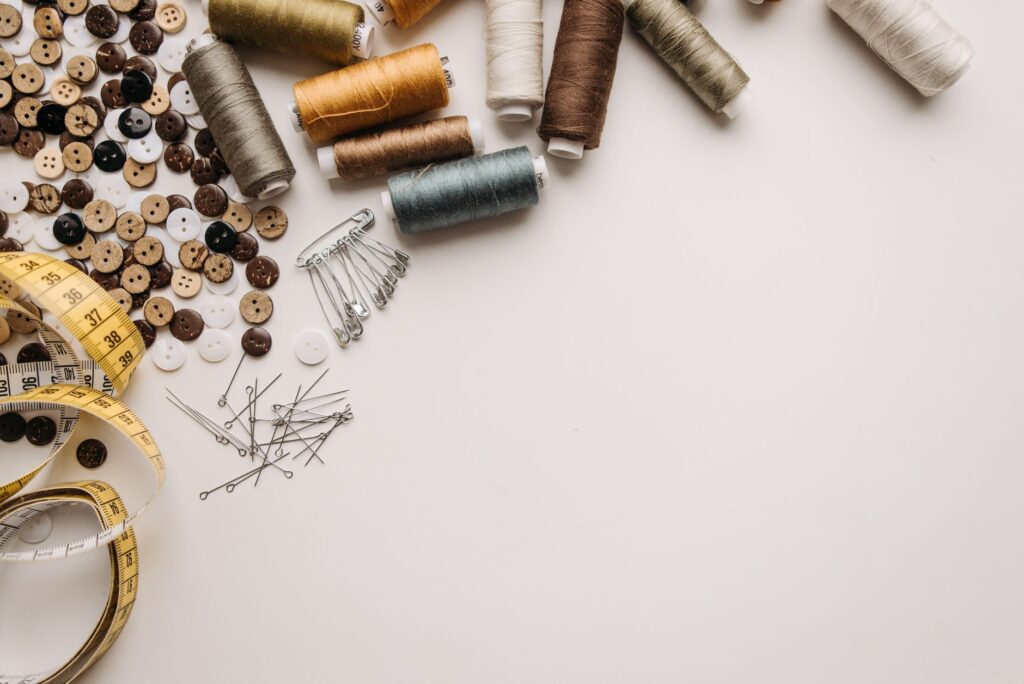 Fashion fixes like safety pins and double-sided tape arranged in a cute container. — wedding day emergency kit
