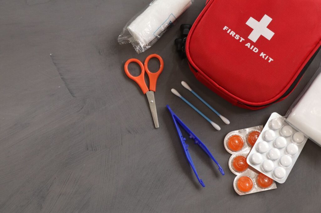 First aid supplies such as band-aids and antiseptic wipes displayed for a wedding emergency kit. — wedding day emergency…