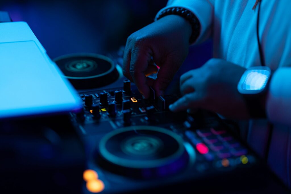 A DJ setting up a sound system with colorful lights for a wedding event. — Las Vegas wedding playlist