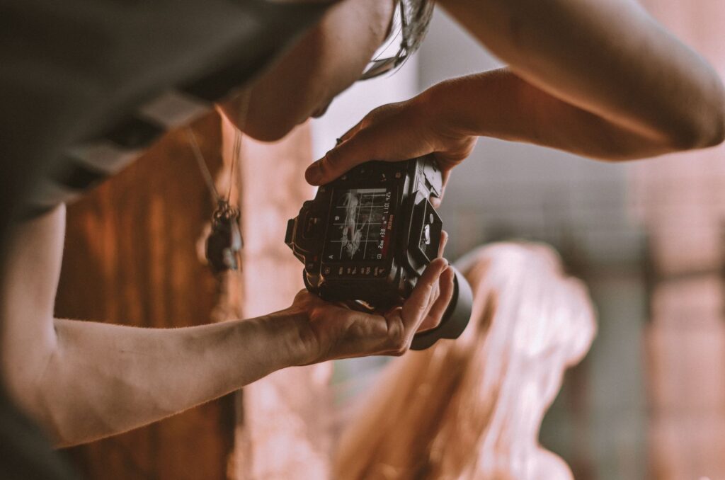 A behind-the-scenes image of a photographer in action, capturing a couple's special moment. — best wedding photographers…