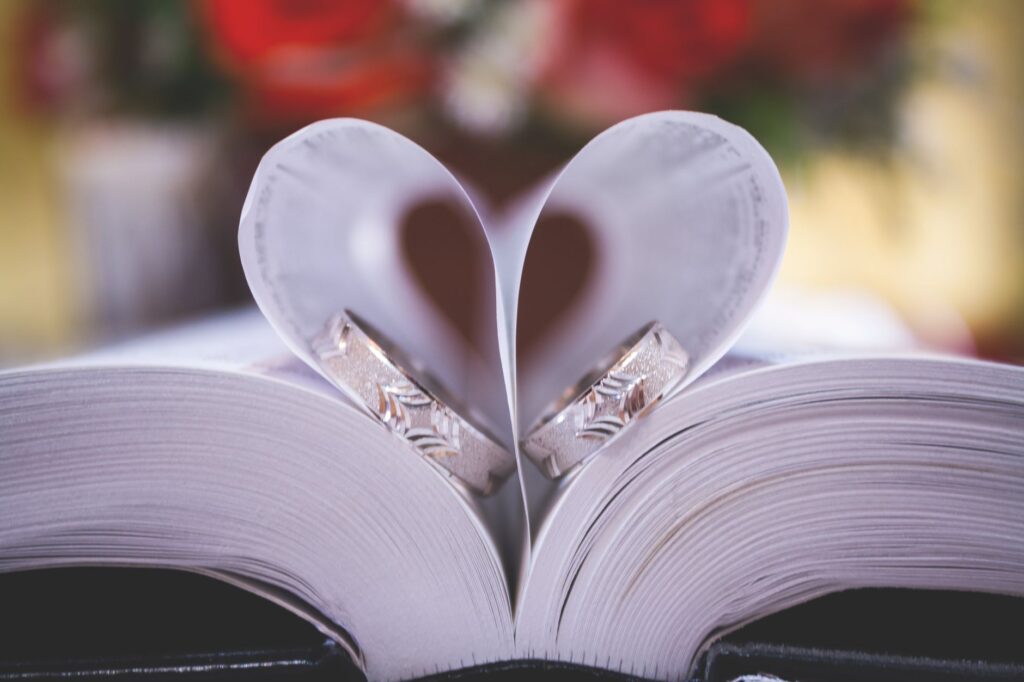 A close-up of a wedding ring and marriage license on a Las Vegas-themed background. — Las Vegas elopement planning