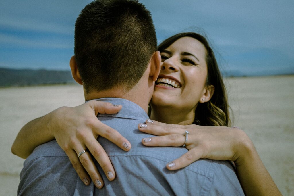 A close-up of a wedding ring on a desert landscape backdrop. — Las Vegas elopement planning