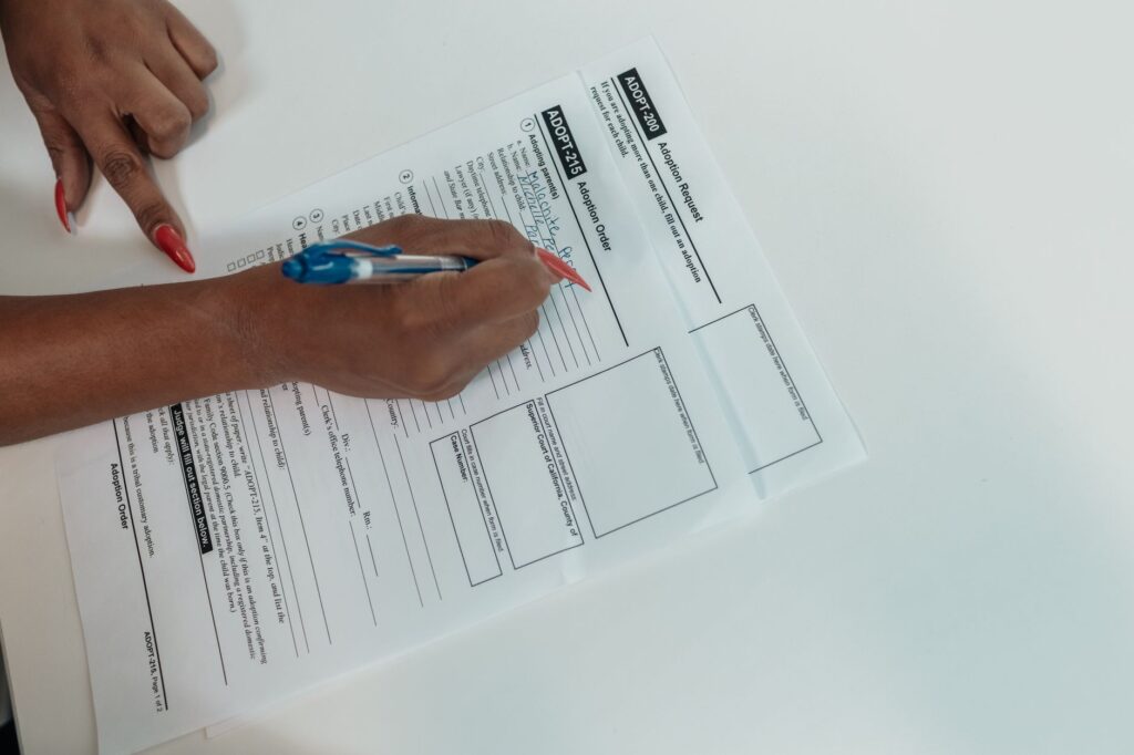 A close-up of the marriage license application form with a pen ready for signatures. — Las Vegas marriage license requir…