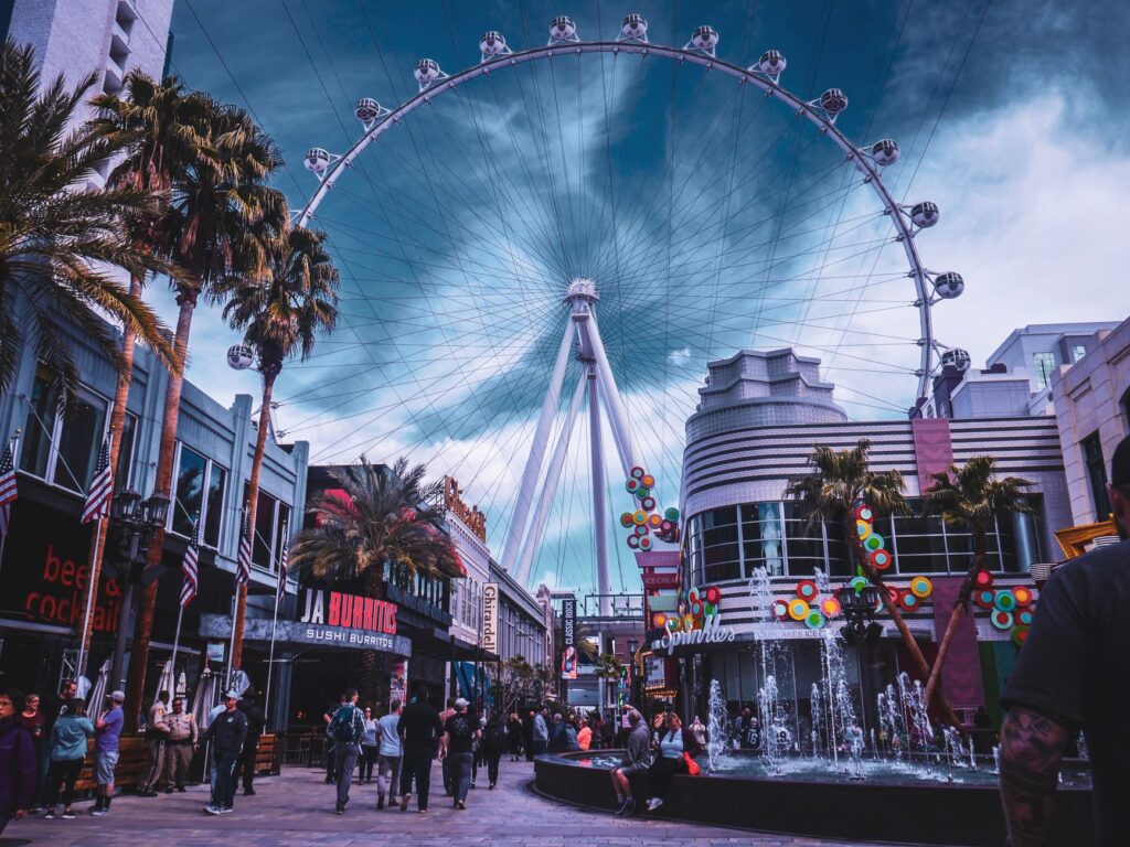 A couple celebrating their wedding atop the High Roller Observation Wheel, with the Las Vegas Strip in the background. —…