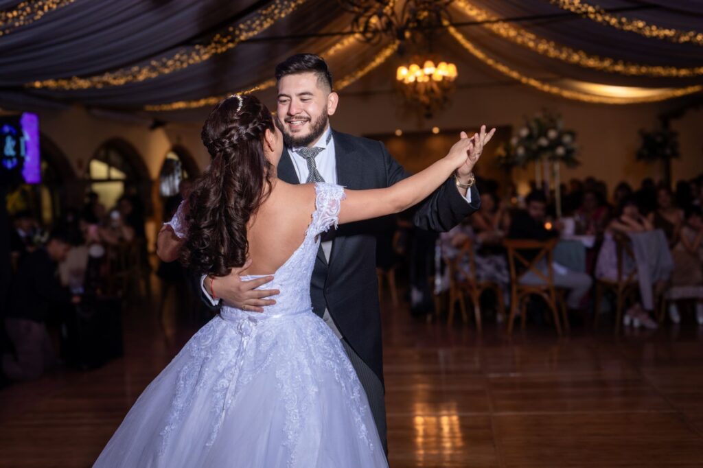 A couple celebrating their wedding with friends and family in a luxurious hotel ballroom. — destination wedding Las Vegas