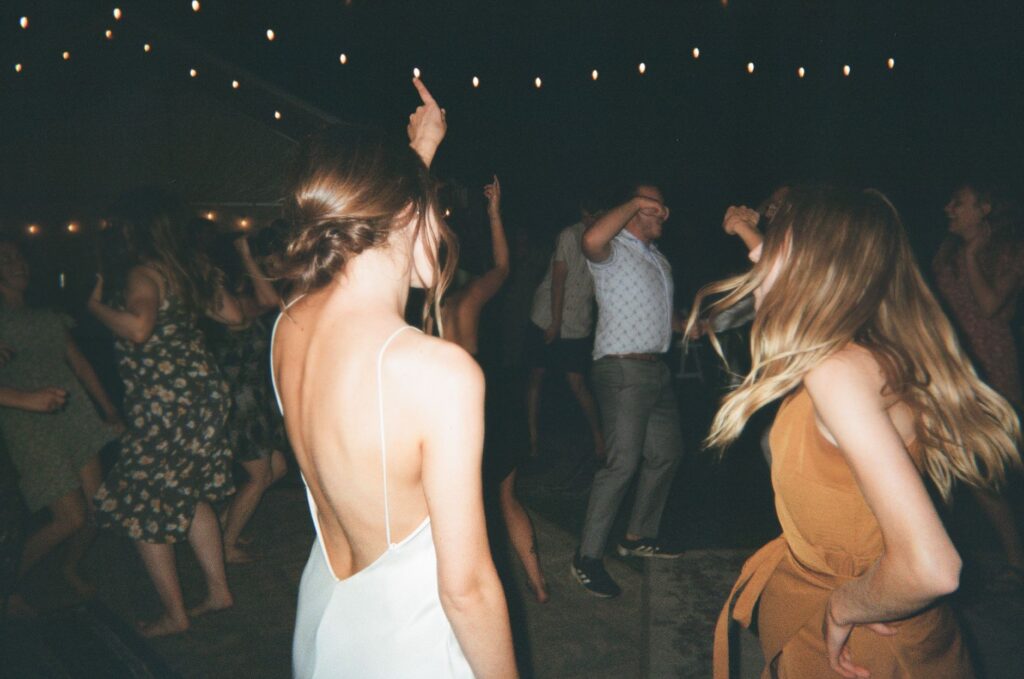 A couple enjoying a summer wedding reception with lights and music. — best time to get married in Las Vegas
