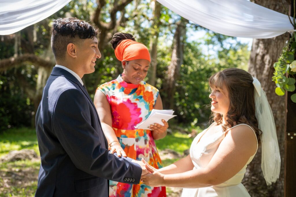 A couple exchanging vows in a summer outdoor setting under the bright sun. — best time to marry in Las Vegas