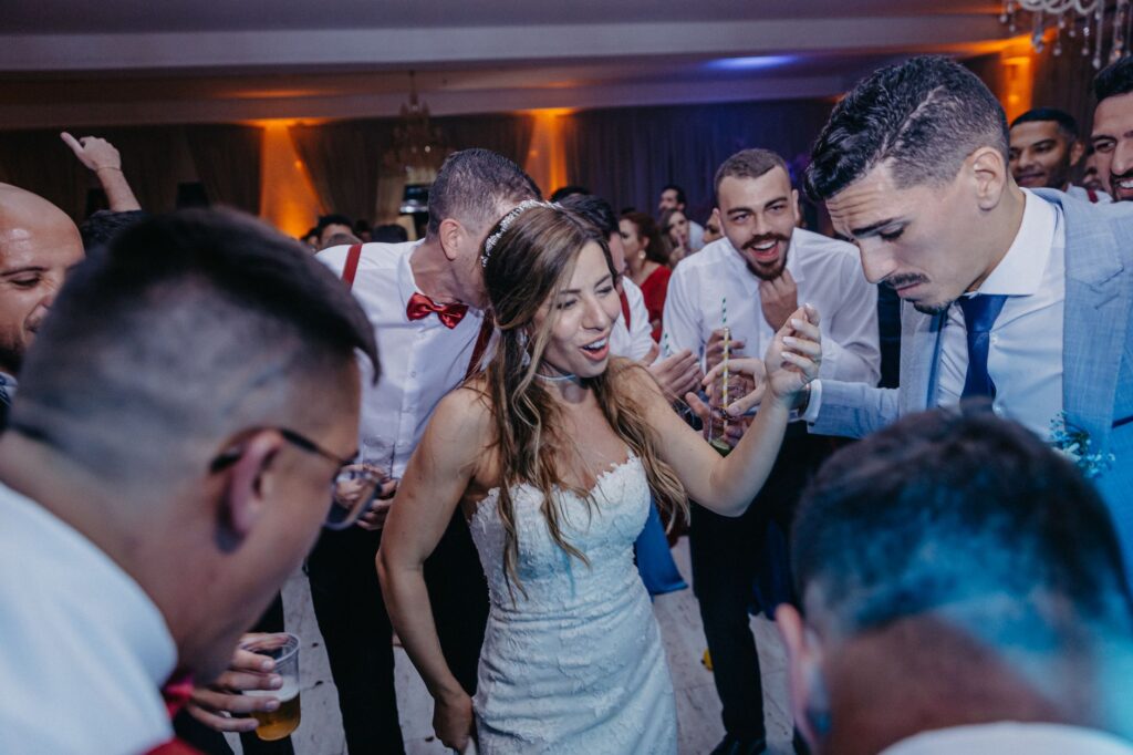 A happy bride and groom dancing at their reception, surrounded by guests. — Las Vegas wedding vendors
