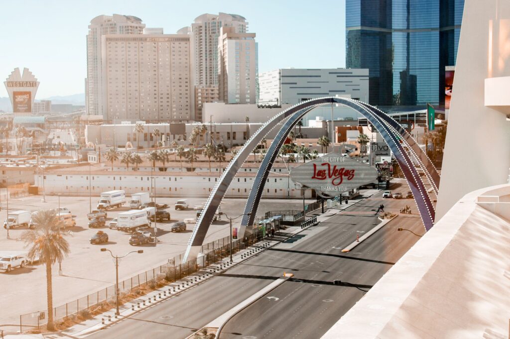 A joyful couple posing with their wedding photographer in front of a famous Las Vegas landmark. — Las Vegas wedding phot…