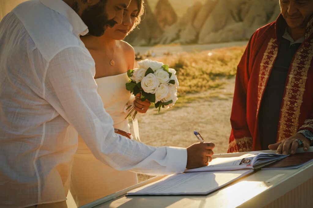 A wedding officiant holding a marriage certificate with a couple looking excited. — Las Vegas wedding officiant