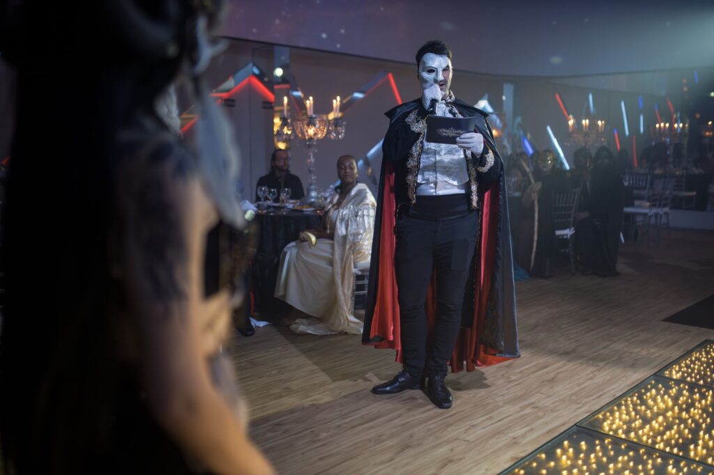 An elegant masquerade ball wedding with guests in masks and formal attire. — unique wedding themes Las Vegas