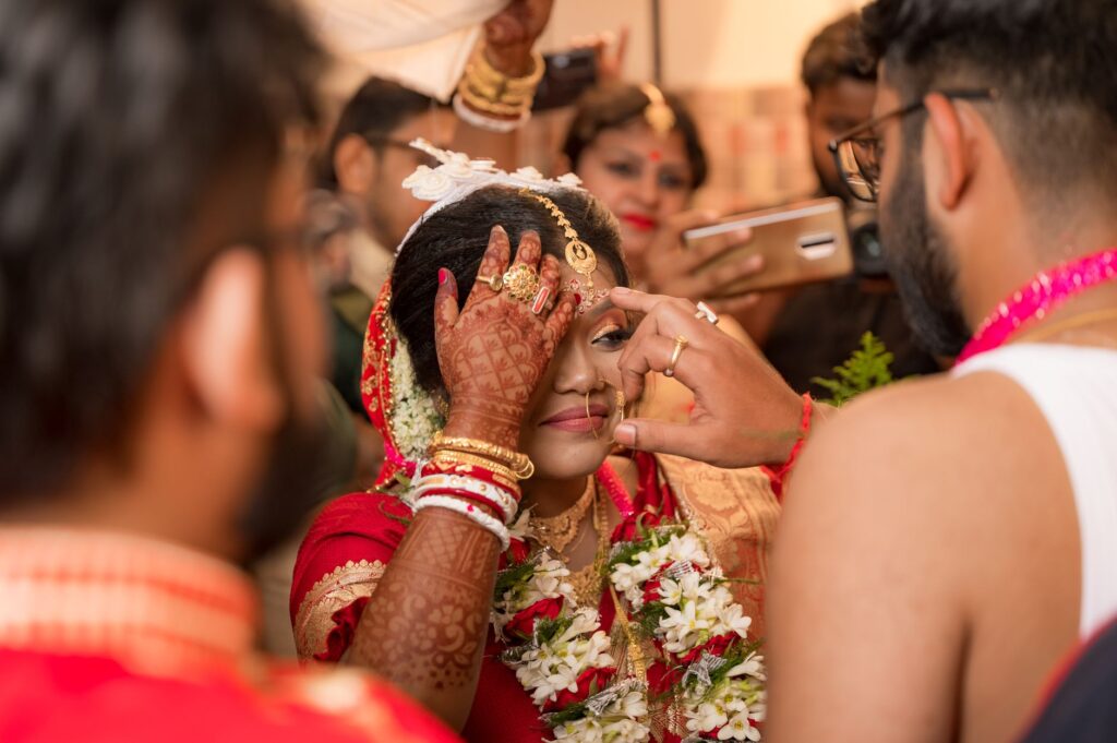 An image showing a wedding photographer capturing candid moments during a ceremony. — Las Vegas wedding photography