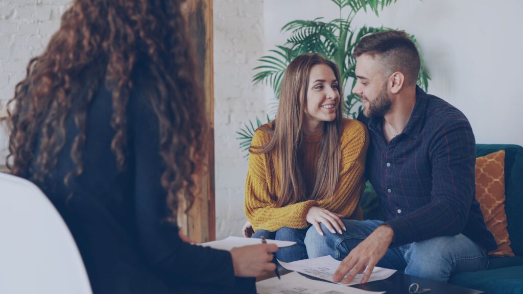 Couple discussing plans with a wedding officiant in a cozy setting — Las Vegas wedding officiant