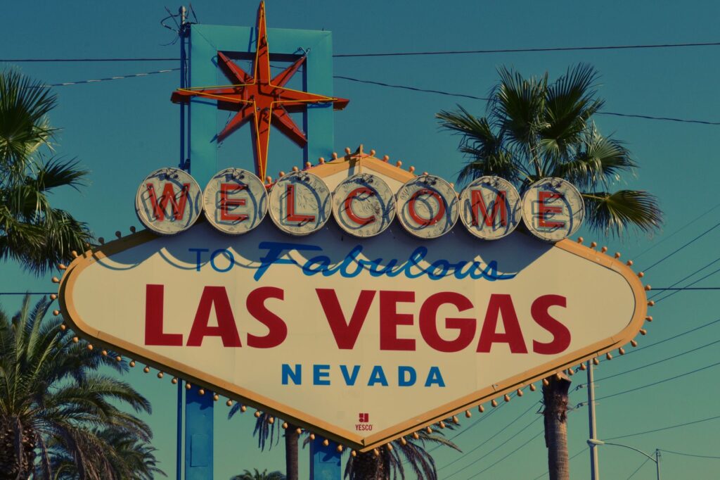 Couple exchanging vows in front of the iconic Las Vegas sign — Las Vegas elopement guide